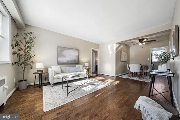 a living room with furniture and a chandelier