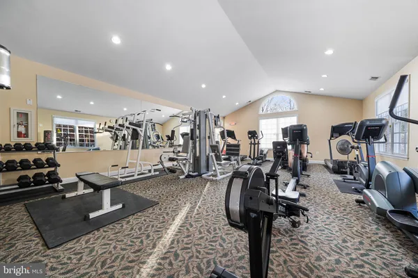 a room with lots of chairs and mirrors
