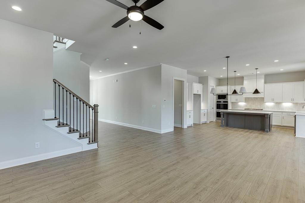 452 Thunder Road Buford, GA 30518 - Photo 11 of 80 a view of kitchen with wooden floor and electronic appliances
