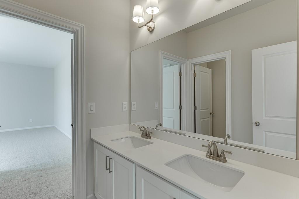 452 Thunder Road Buford, GA 30518 - Photo 30 of 80 a bathroom with double sink and a mirror