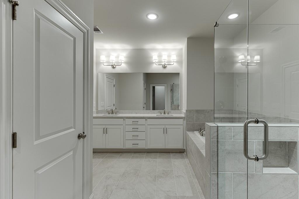 452 Thunder Road Buford, GA 30518 - Photo 44 of 80 a large bathroom with a mirror and a shower