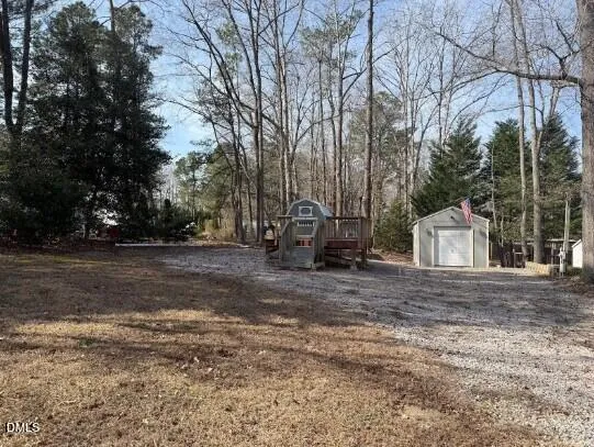 a view of a house with yard and trees