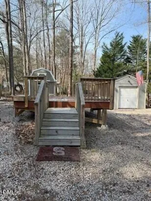 a view of backyard with wooden deck and a slide