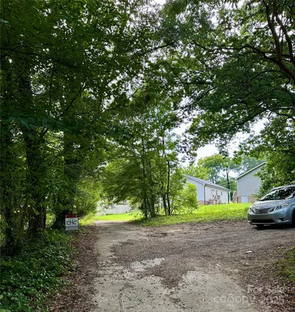 a view of a house with a tree in the background