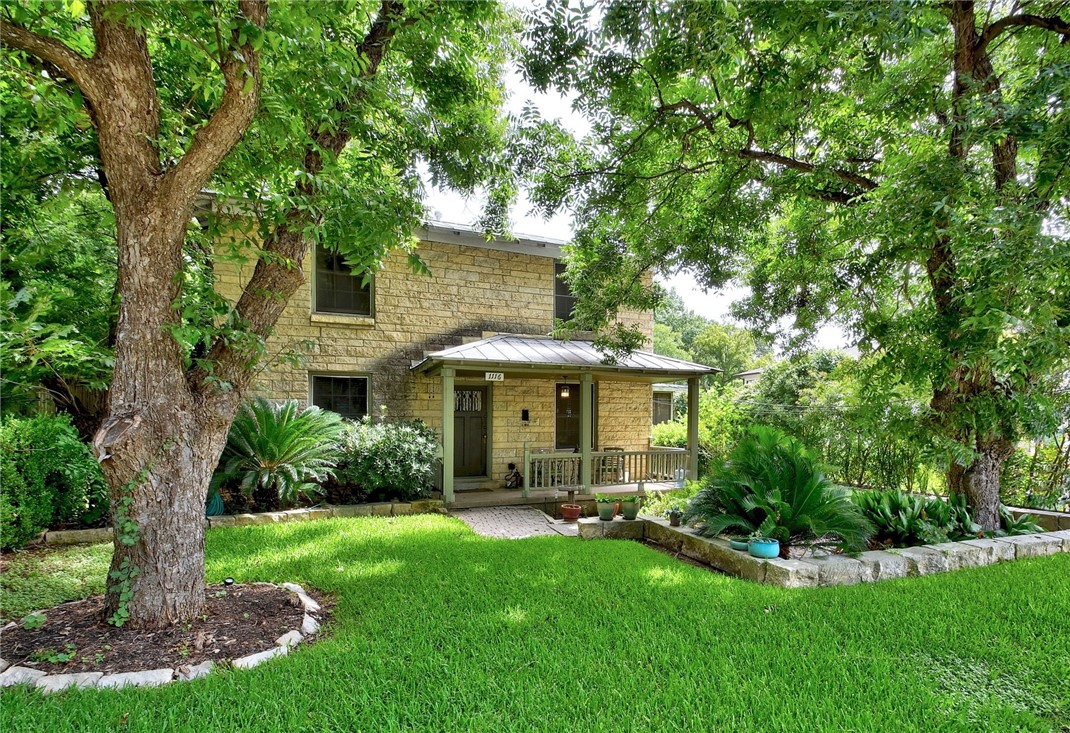 a view of a house with backyard and a tree
