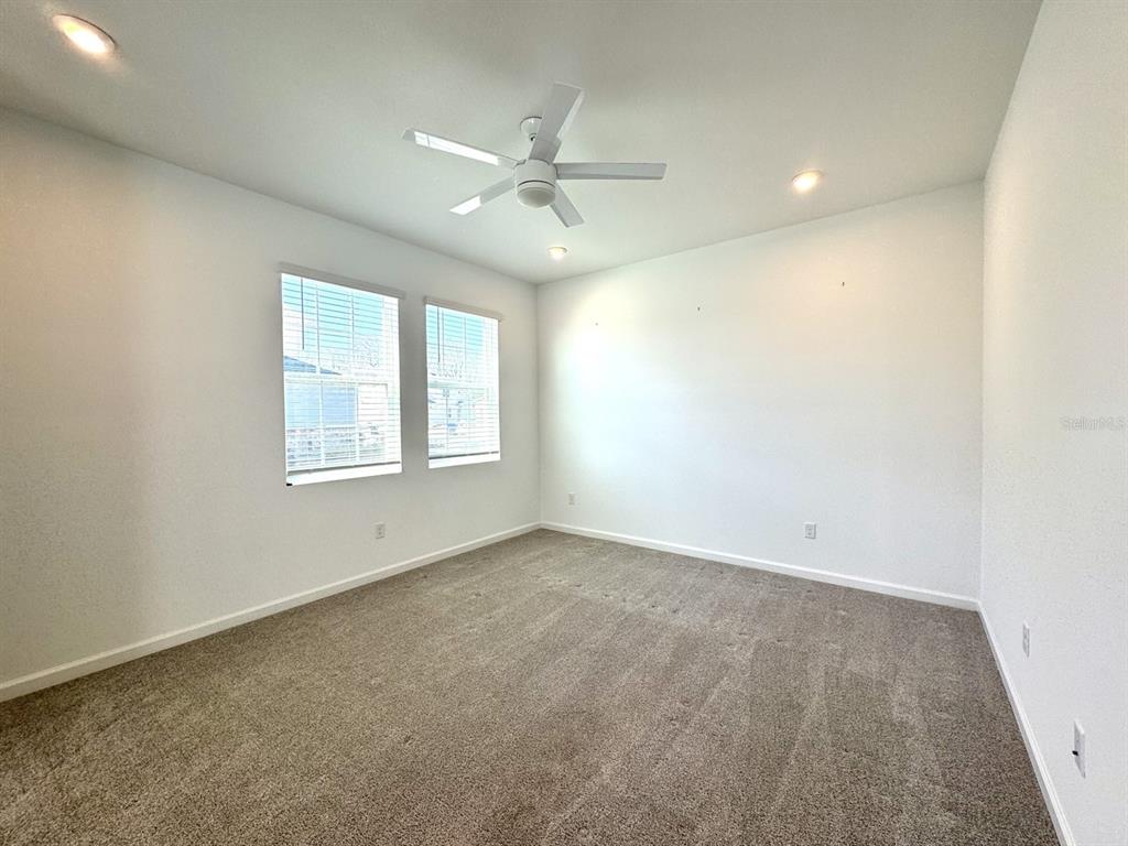 1025 Spring Palms Loop Orlando, FL 32828 - Photo 7 of 9 an empty room with windows and fan