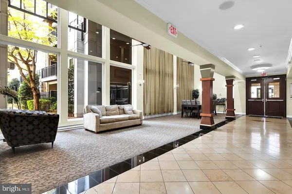 a living room with furniture and large windows