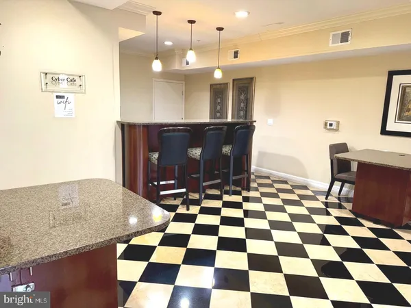a room with a black white checkered floor with a dining table and a black white checkered floor
