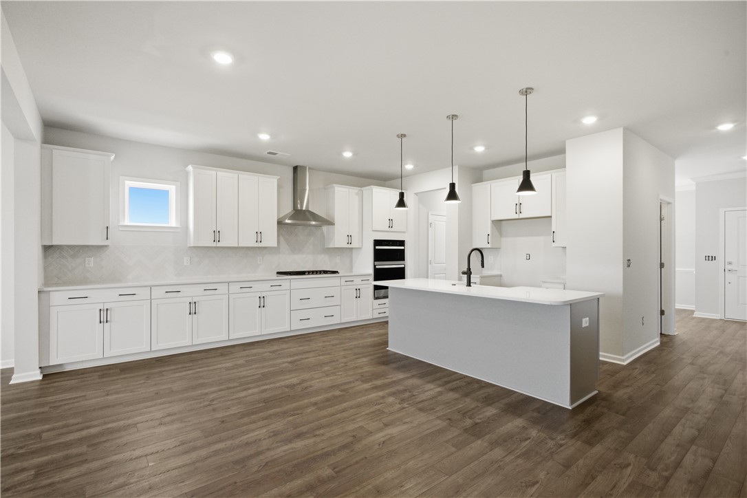 552 Hydrangea Street, Unit LOT 66 Seneca, SC 29678 - Photo 8 of 31 Culinary dreams come alive in this well-lit kitchen with a spacious island and sleek, modern finishes.