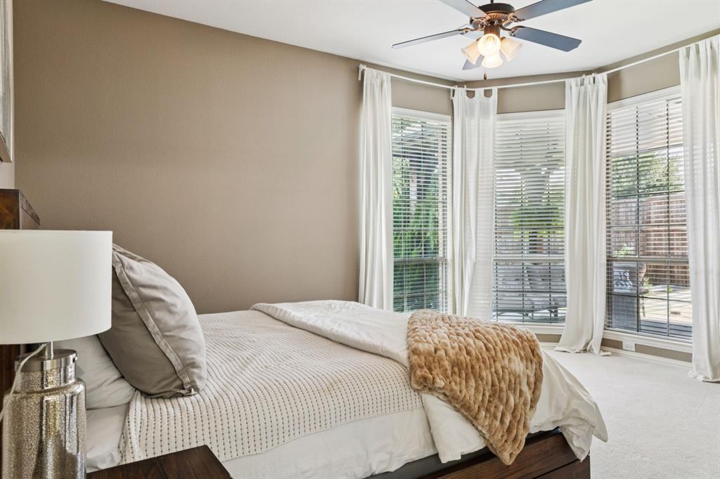 910 Fox Ridge Trail Prosper, TX 75078 - Photo 12 of 25 a bedroom with a bed and glass window