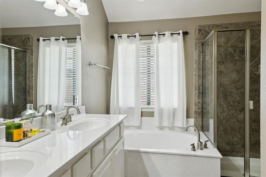 910 Fox Ridge Trail Prosper, TX 75078 - Photo 14 of 25 a bathroom with a granite countertop sink and a bathtub