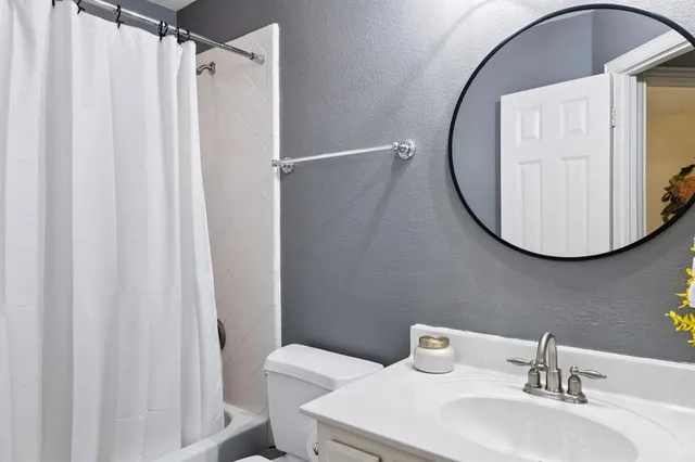 a bathroom with a sink mirror and vanity