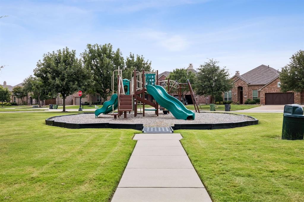 910 Fox Ridge Trail Prosper, TX 75078 - Photo 25 of 25 a view of a swimming pool with a garden and plants
