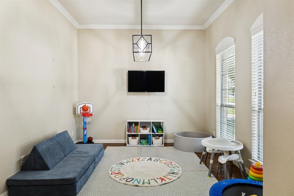 910 Fox Ridge Trail Prosper, TX 75078 - Photo 3 of 25 a living room with furniture and a flat screen tv