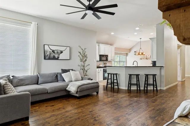 a living room with furniture and kitchen view