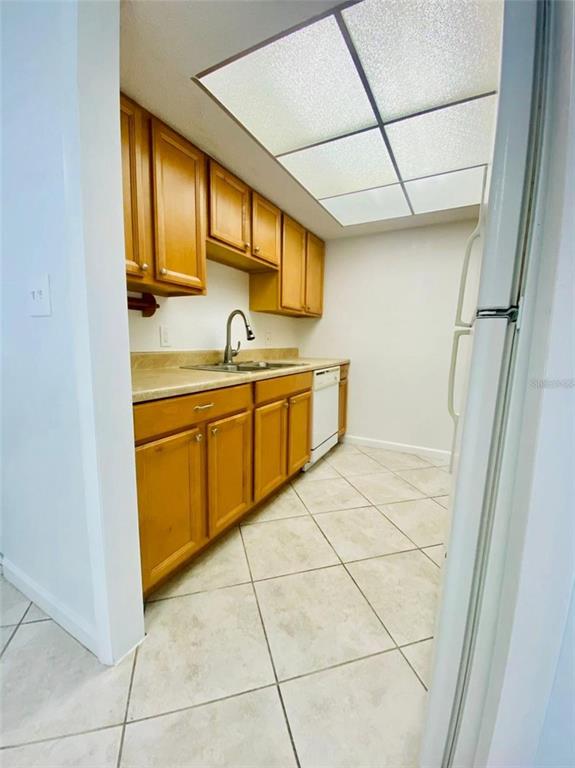 633 North Keene Road, Unit C Clearwater, FL 33755 - Photo 6 of 20 a kitchen with a sink window and cabinets
