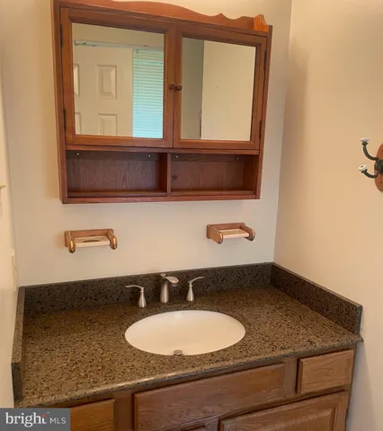 a bathroom with a sink granite and mirror