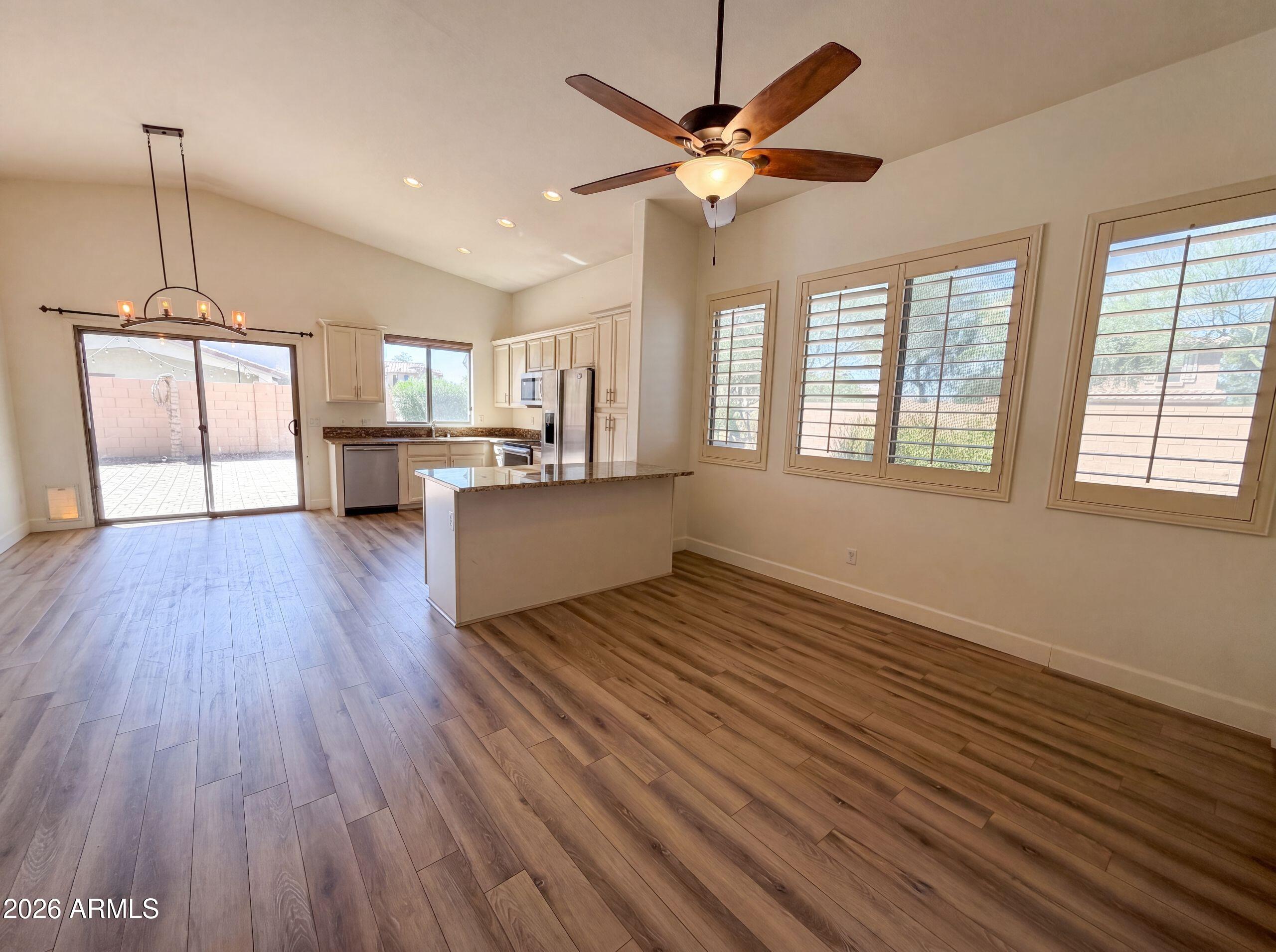 3951 East Timberline Road Gilbert, AZ 85297 - Photo 10 of 28 a view of an empty room with a window and wooden floor