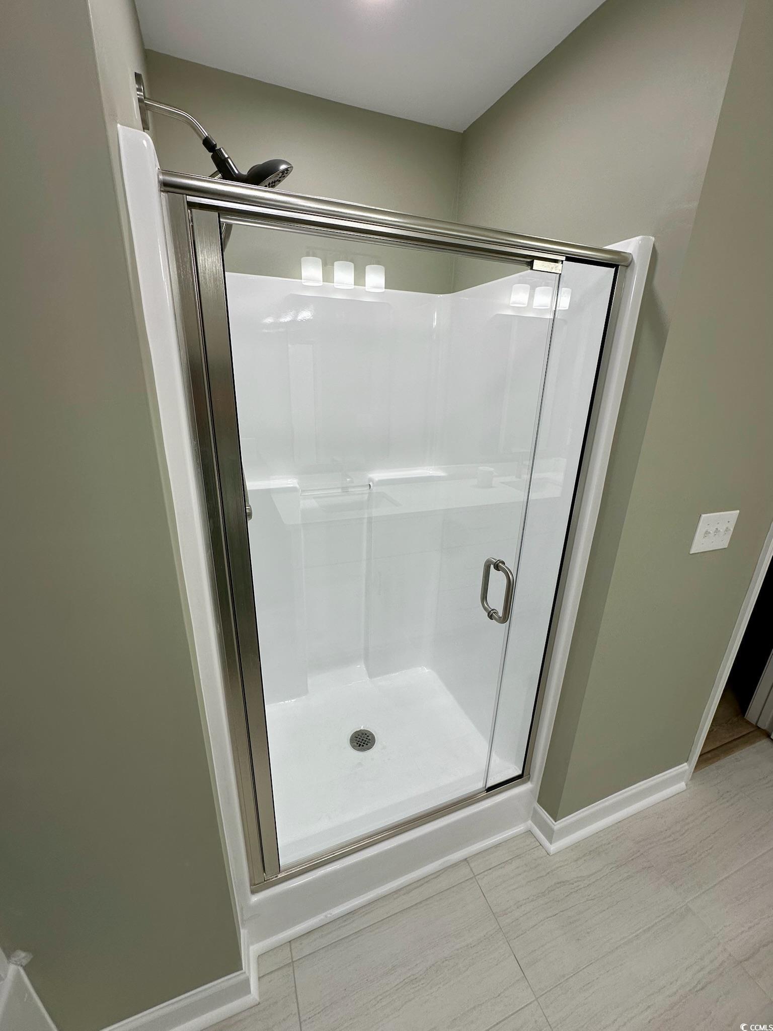 9 Pistachio Loop, Unit D Murrells Inlet, SC 29576 - Photo 13 of 21 Bathroom with a stall shower and light tile patterned flooring