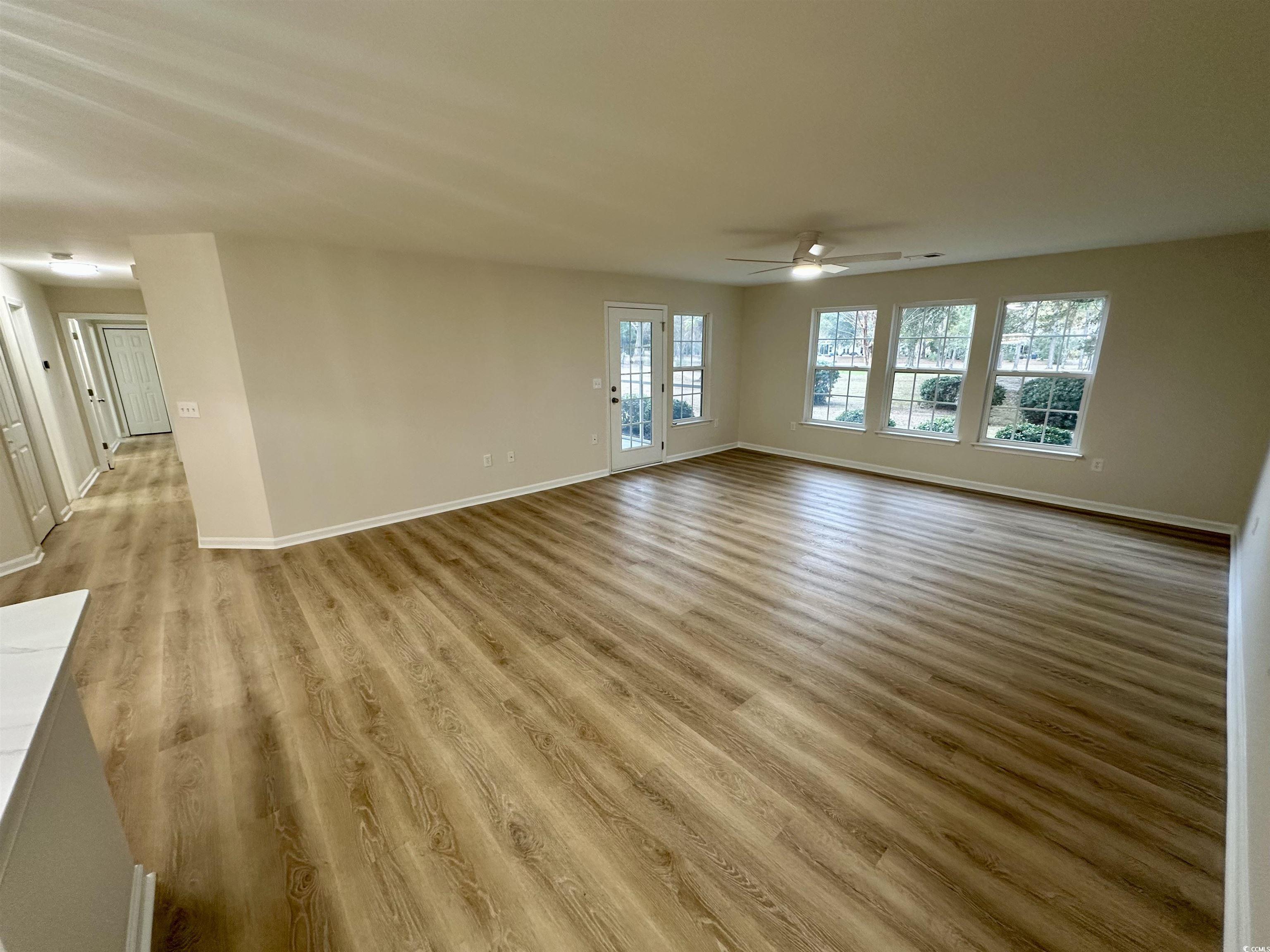 9 Pistachio Loop, Unit D Murrells Inlet, SC 29576 - Photo 8 of 21 Unfurnished living room with light wood-type flooring and a ceiling fan