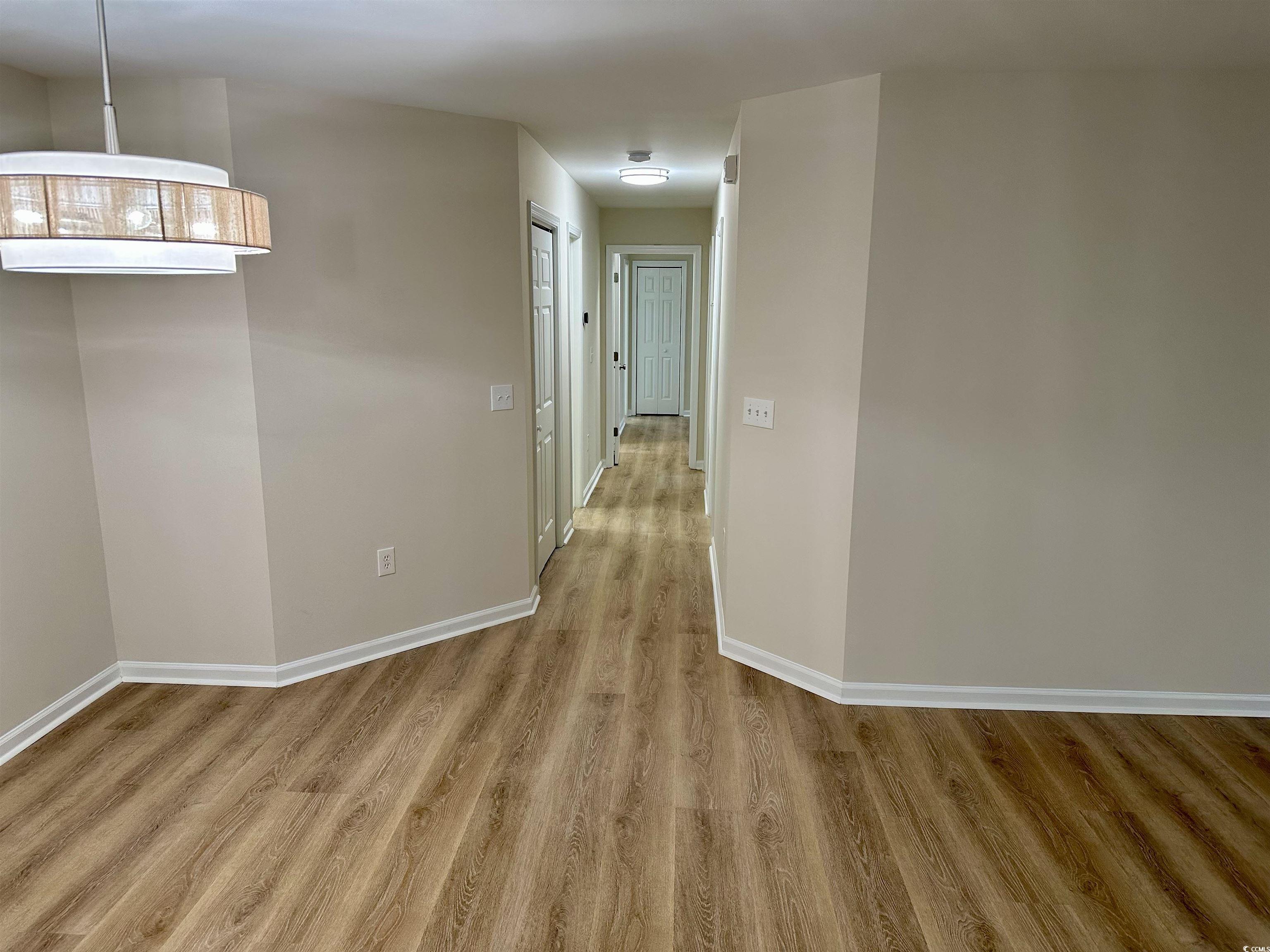 9 Pistachio Loop, Unit D Murrells Inlet, SC 29576 - Photo 9 of 21 Hall featuring baseboards and wood finished floors