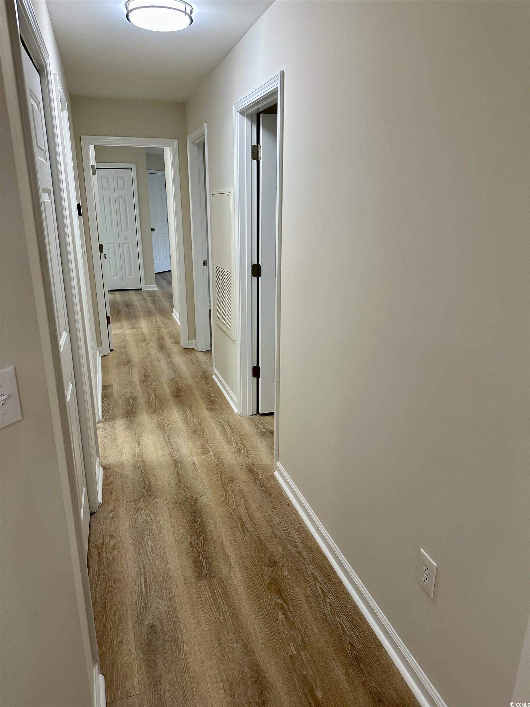 9 Pistachio Loop, Unit D Murrells Inlet, SC 29576 - Photo 10 of 21 Corridor featuring light wood-style flooring and baseboards