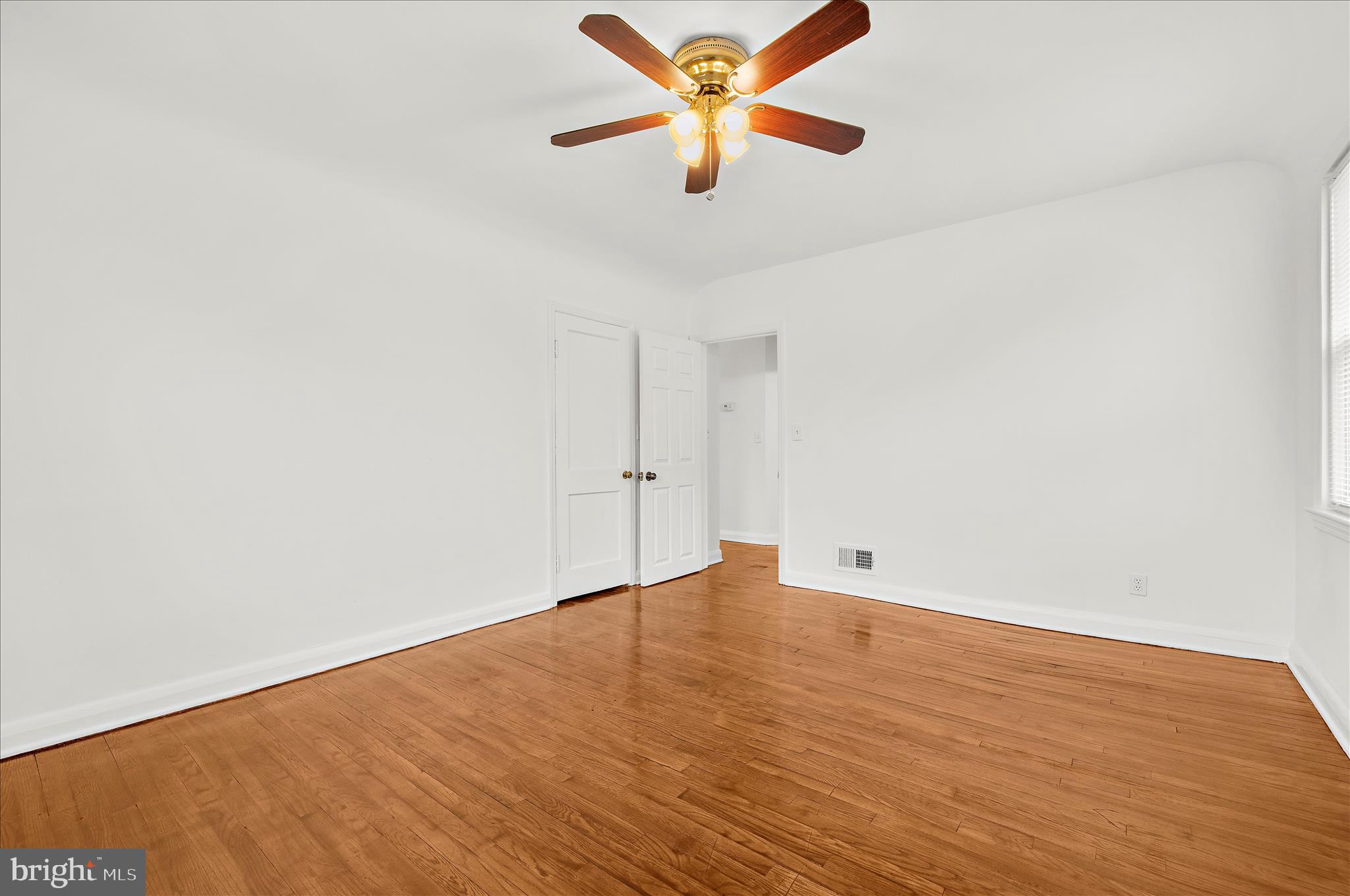 5701 Magie Street Baltimore, MD 21225 - Photo 12 of 49 wooden floor in an empty room