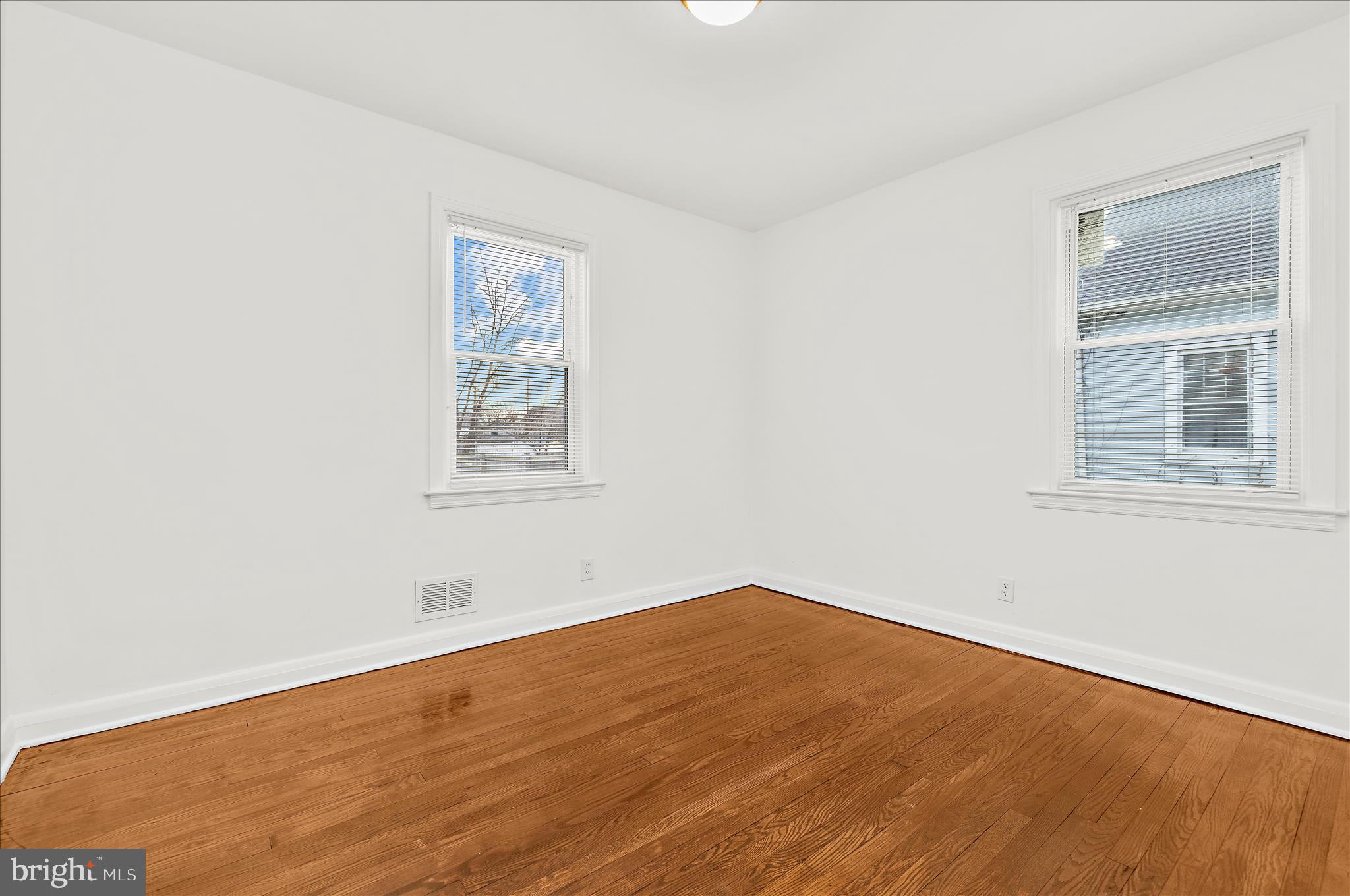 5701 Magie Street Baltimore, MD 21225 - Photo 17 of 49 a view of a big room with wooden floor and windows