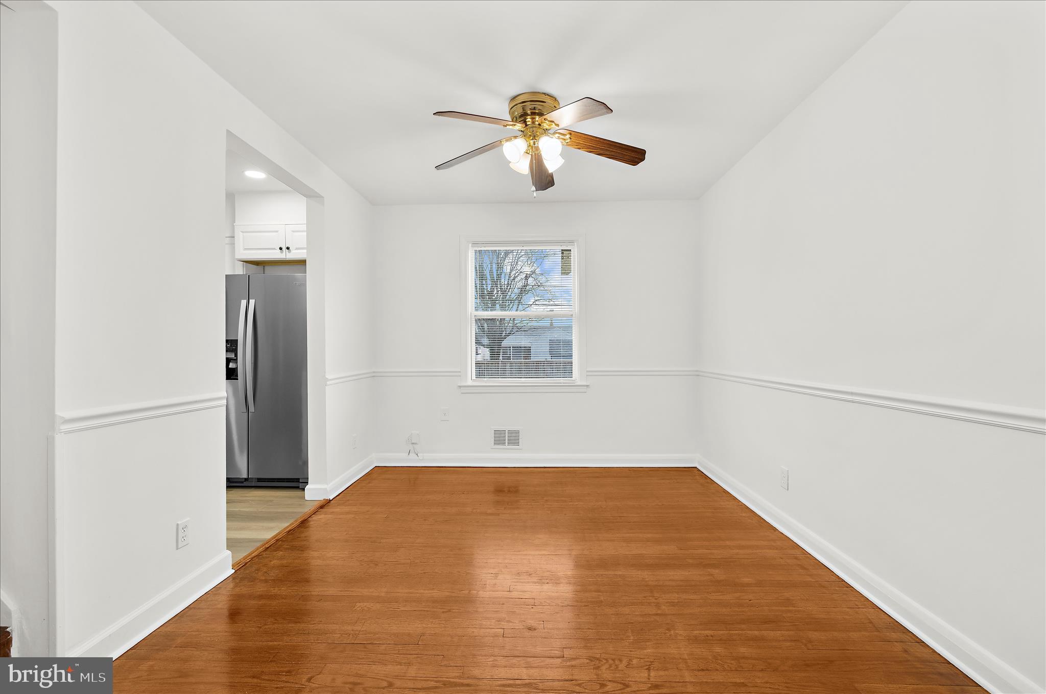 5701 Magie Street Baltimore, MD 21225 - Photo 21 of 49 a view of empty room with wooden floor and fan