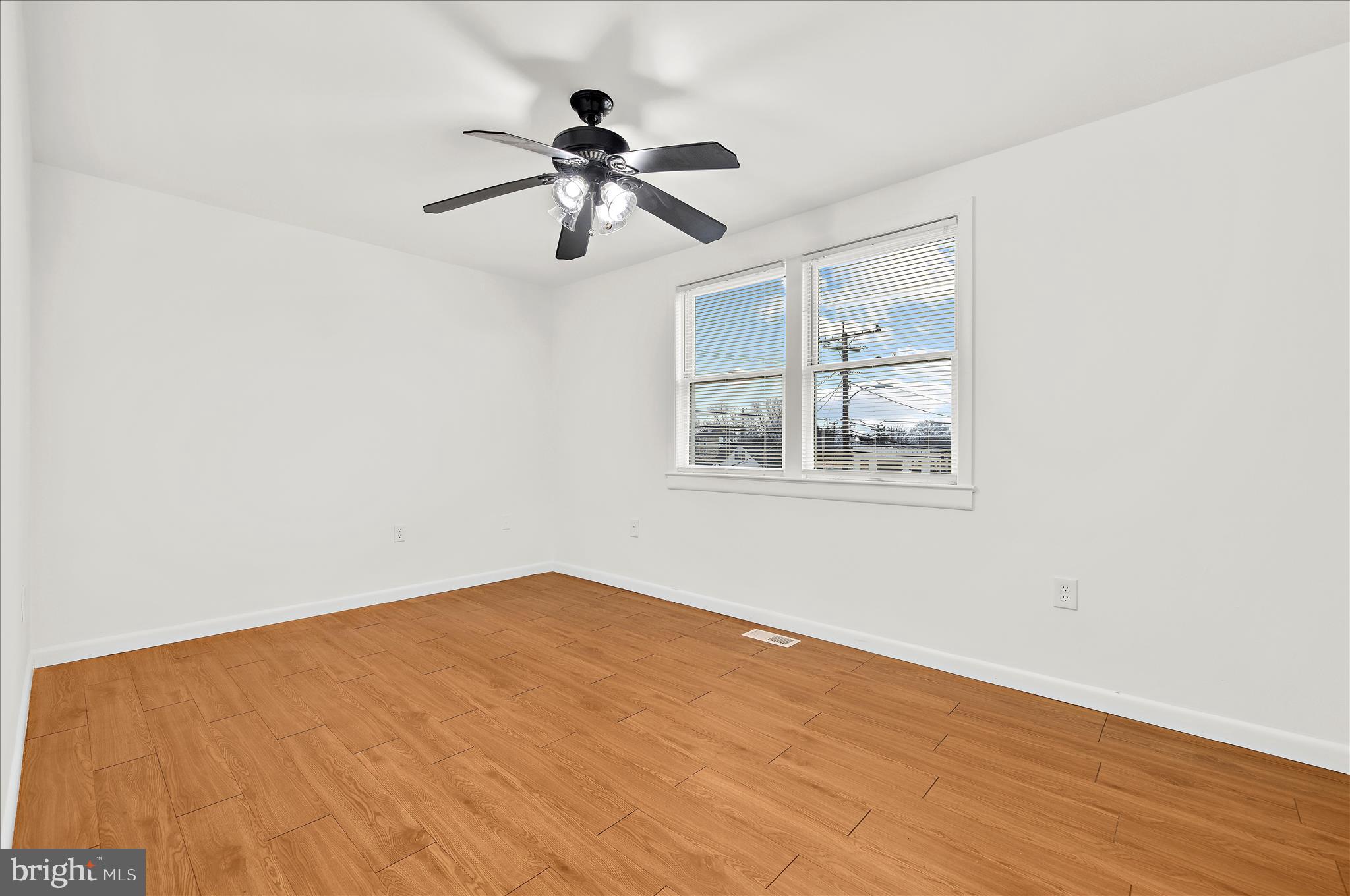 5701 Magie Street Baltimore, MD 21225 - Photo 23 of 49 a view of empty room with wooden floor
