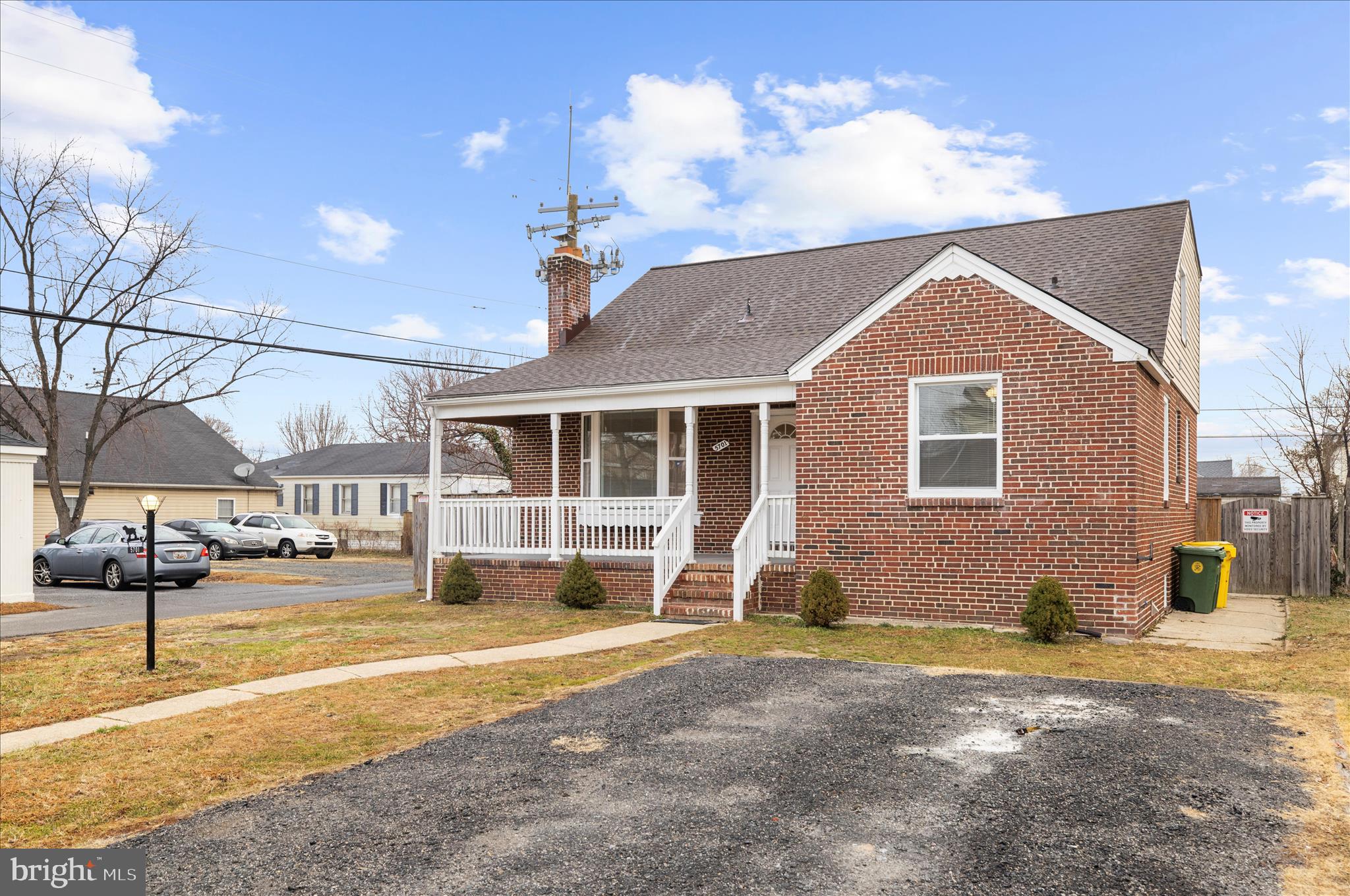 5701 Magie Street Baltimore, MD 21225 - Photo 3 of 49 a front view of a house with a yard