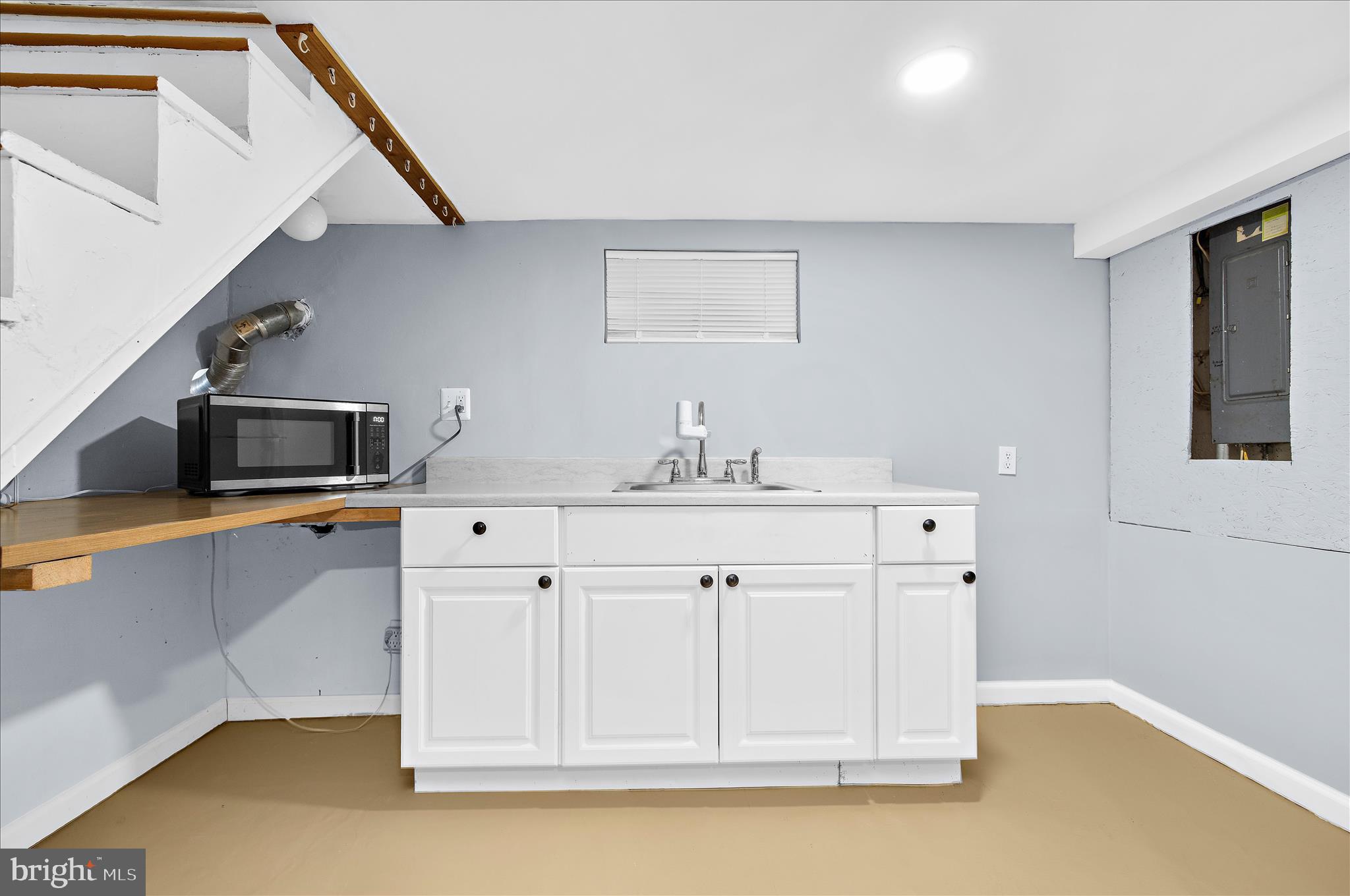 5701 Magie Street Baltimore, MD 21225 - Photo 31 of 49 a kitchen with stainless steel appliances cabinets and a kitchen island