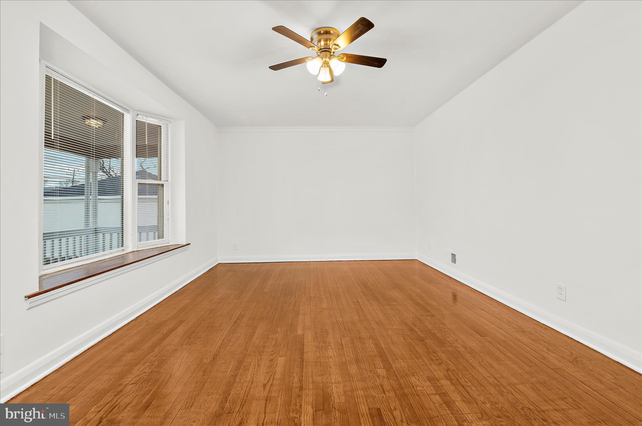 5701 Magie Street Baltimore, MD 21225 - Photo 7 of 49 a view of an empty room with a window