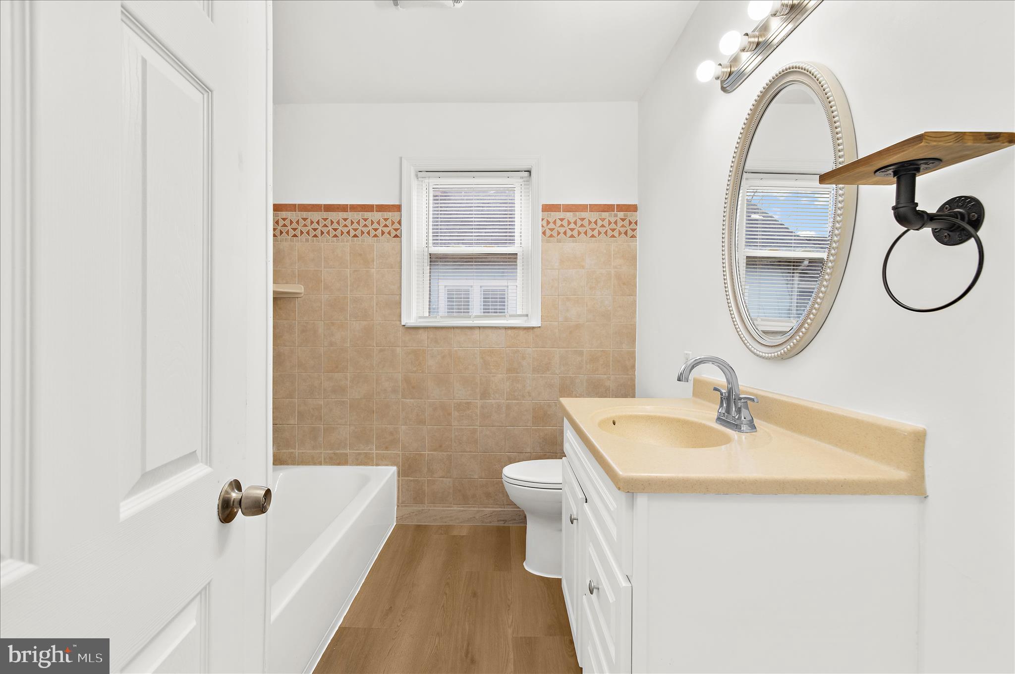 5701 Magie Street Baltimore, MD 21225 - Photo 8 of 49 a bathroom with a sink a mirror and a shower