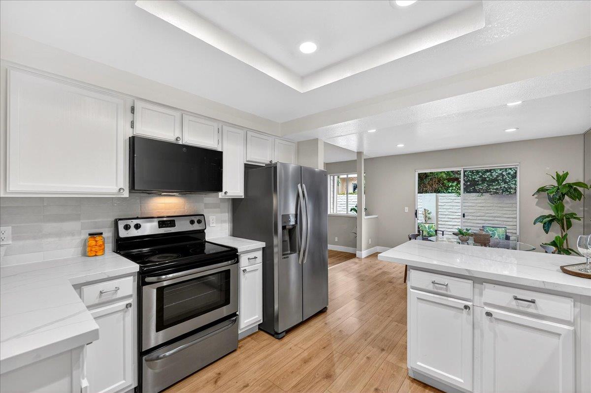 244 Rachael Place Pleasanton, CA 94566 - Photo 10 of 24 a kitchen with a sink stainless steel appliances and white cabinets