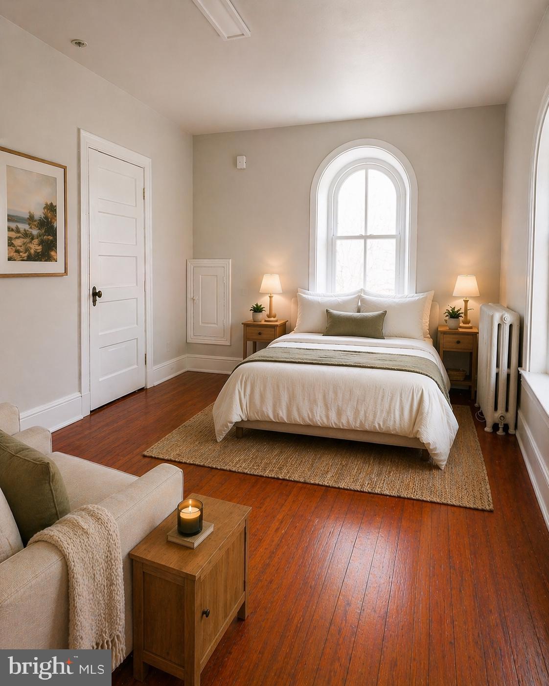 5608-00 Ridge Avenue, Unit F4 Philadelphia, PA 19128 - Photo 3 of 5 a bedroom with a bed and wooden floor