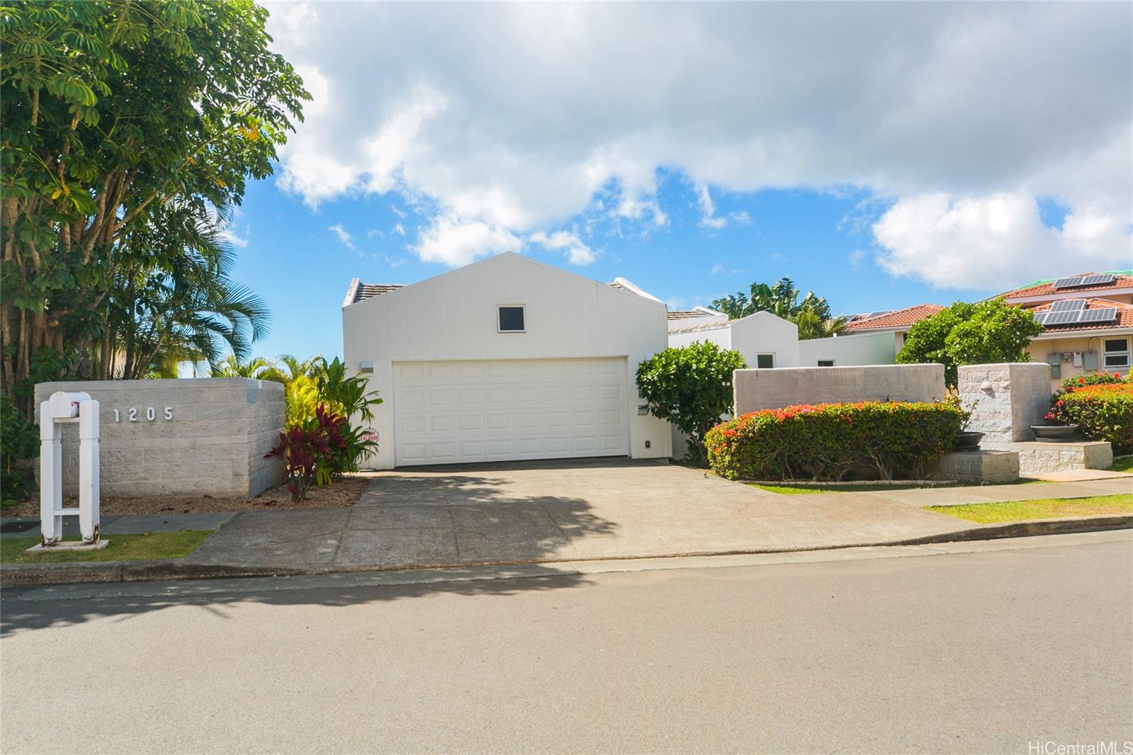 front view of a house with a yard and street view