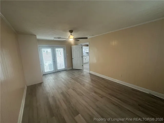 wooden floor in an empty room with a window