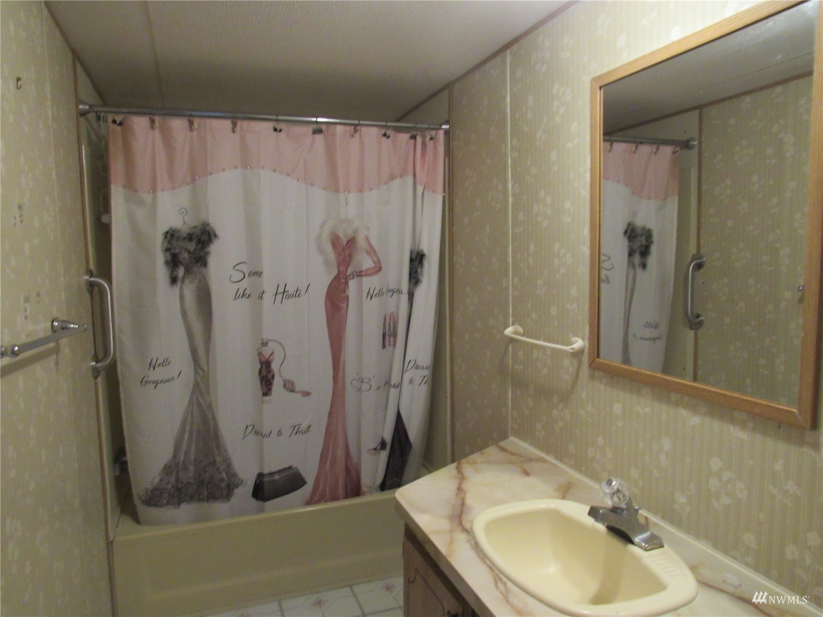 1121 Curtis Street, Unit 18 Sedro-Woolley, WA 98284 - Photo 13 of 20 a bathroom with a sink a mirror a shower and vanity
