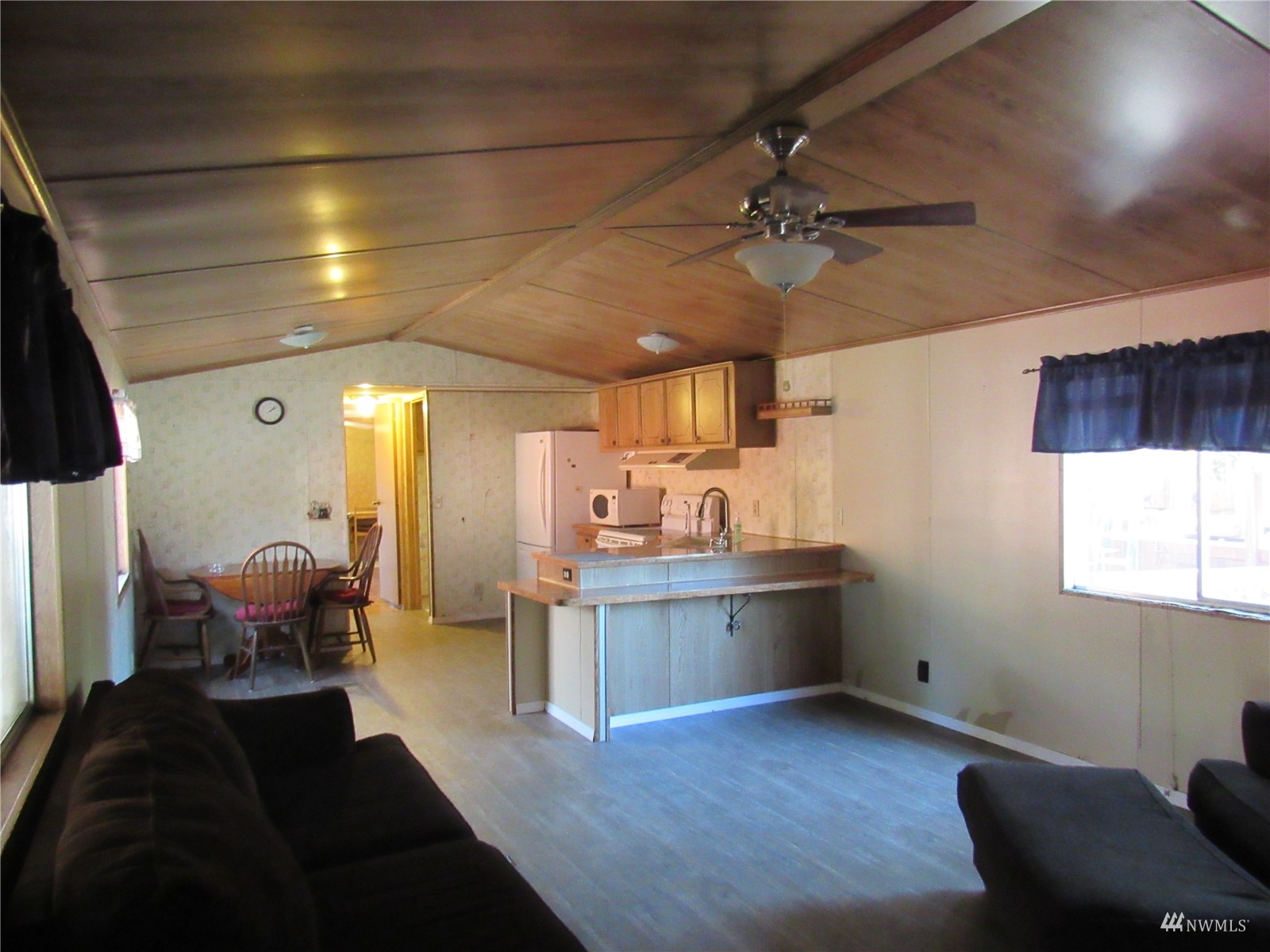 1121 Curtis Street, Unit 18 Sedro-Woolley, WA 98284 - Photo 3 of 20 a living room with a couch wooden floor and a dining table