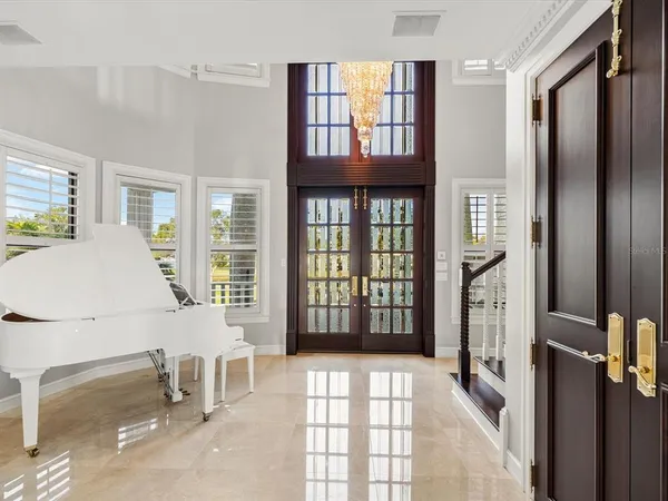 a kitchen with stainless steel appliances a sink a stove a refrigerator cabinets and dining table