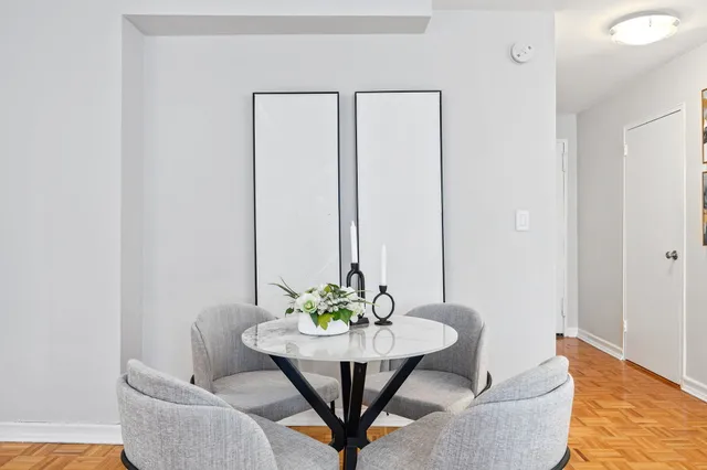 a dining room with furniture and wooden floor