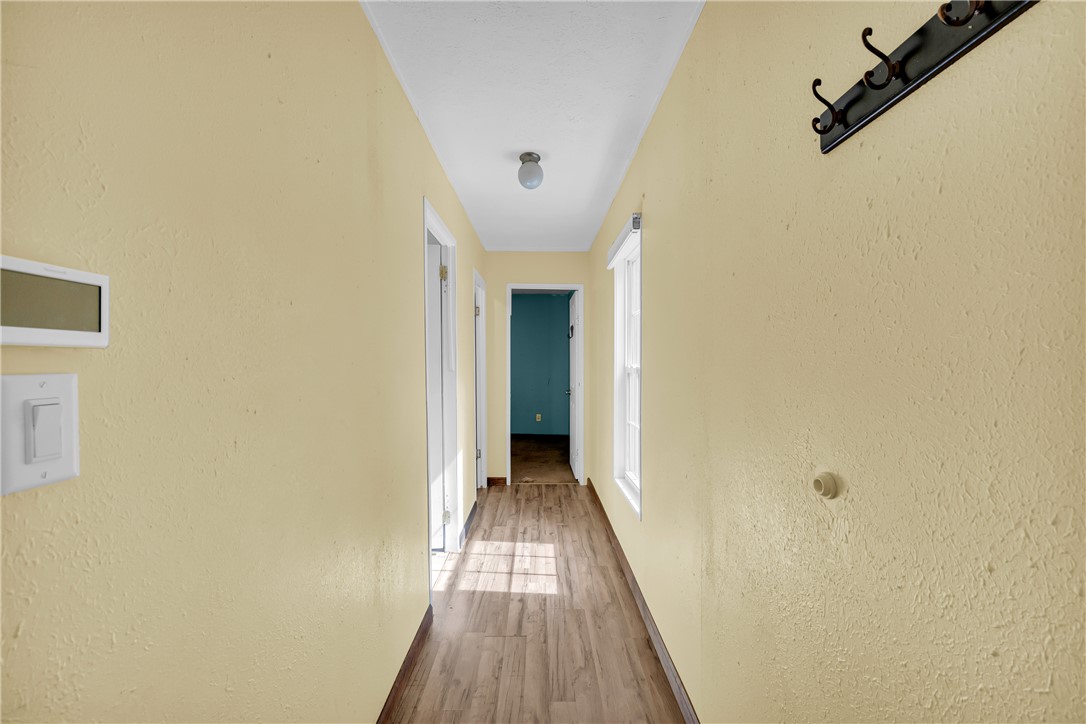 383 Rocky Knoll Road Walhalla, SC 29691 - Photo 36 of 50 A sun-filled hallway features durable wood like flooring and warm-toned walls, leading to additional rooms.