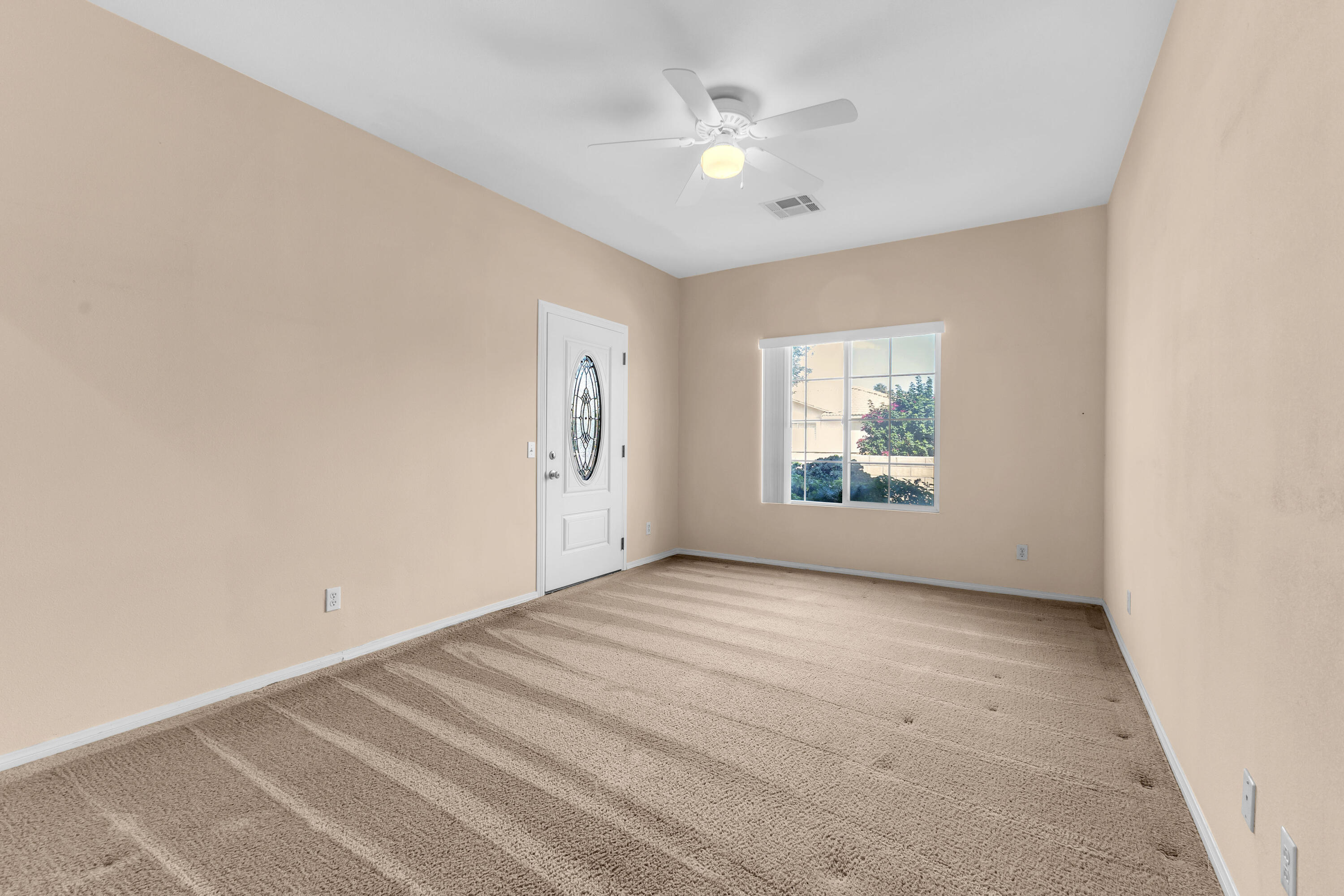 48690 Hepburn Drive Indio, CA 92201 - Photo 11 of 36 an empty room with windows and entrance