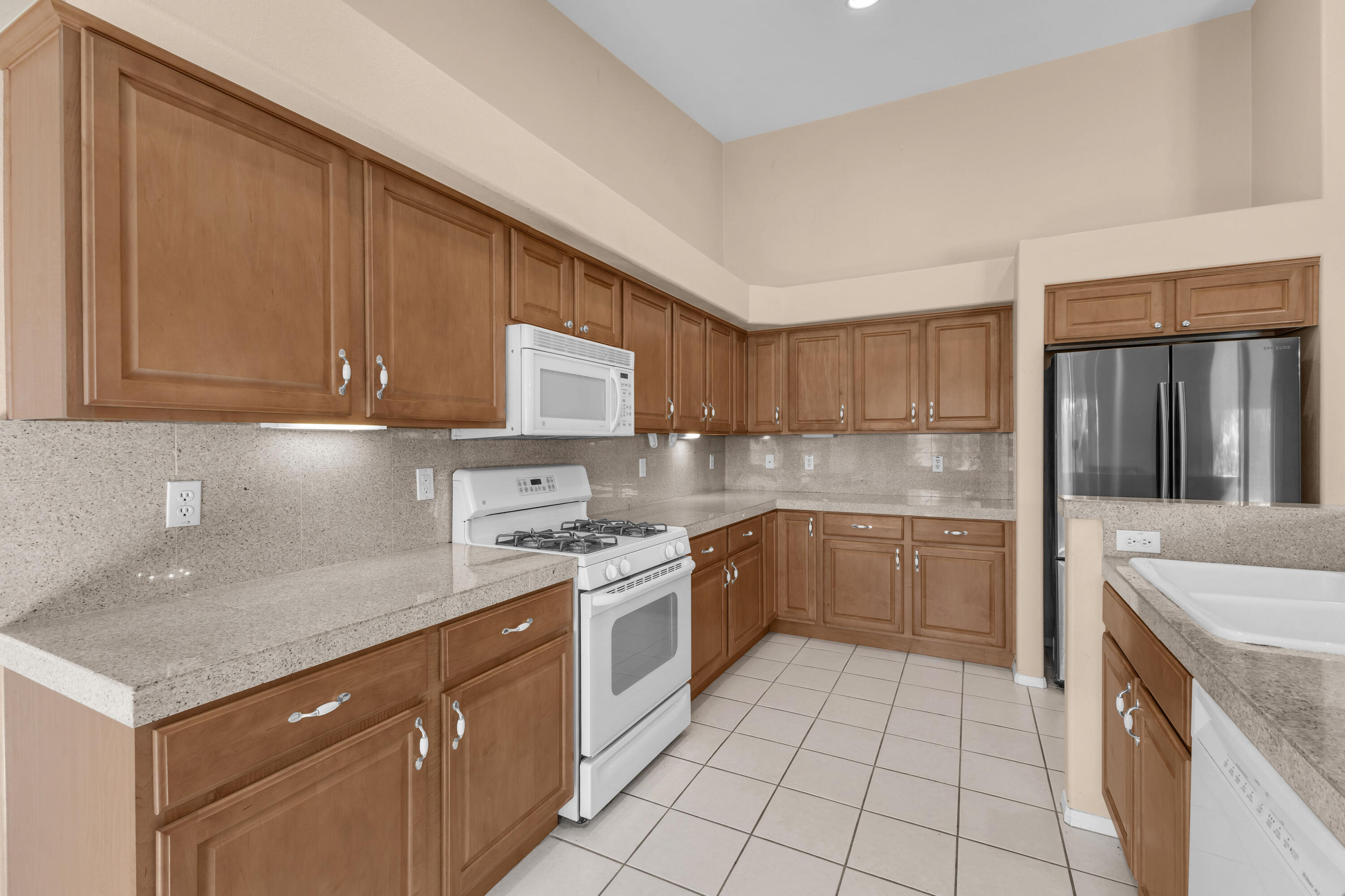 48690 Hepburn Drive Indio, CA 92201 - Photo 14 of 36 a kitchen with a sink stove and cabinets