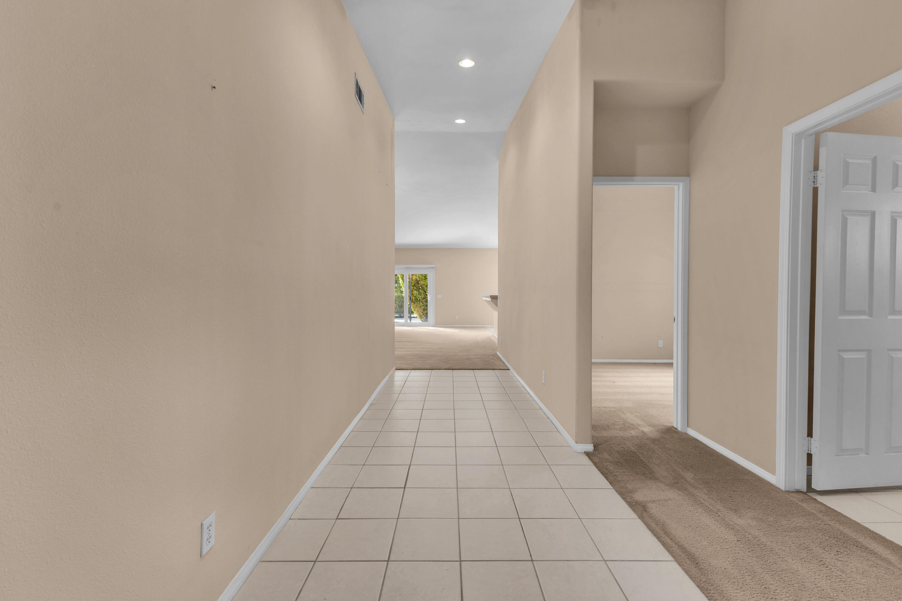 48690 Hepburn Drive Indio, CA 92201 - Photo 19 of 36 a view of a hallway with a chandelier