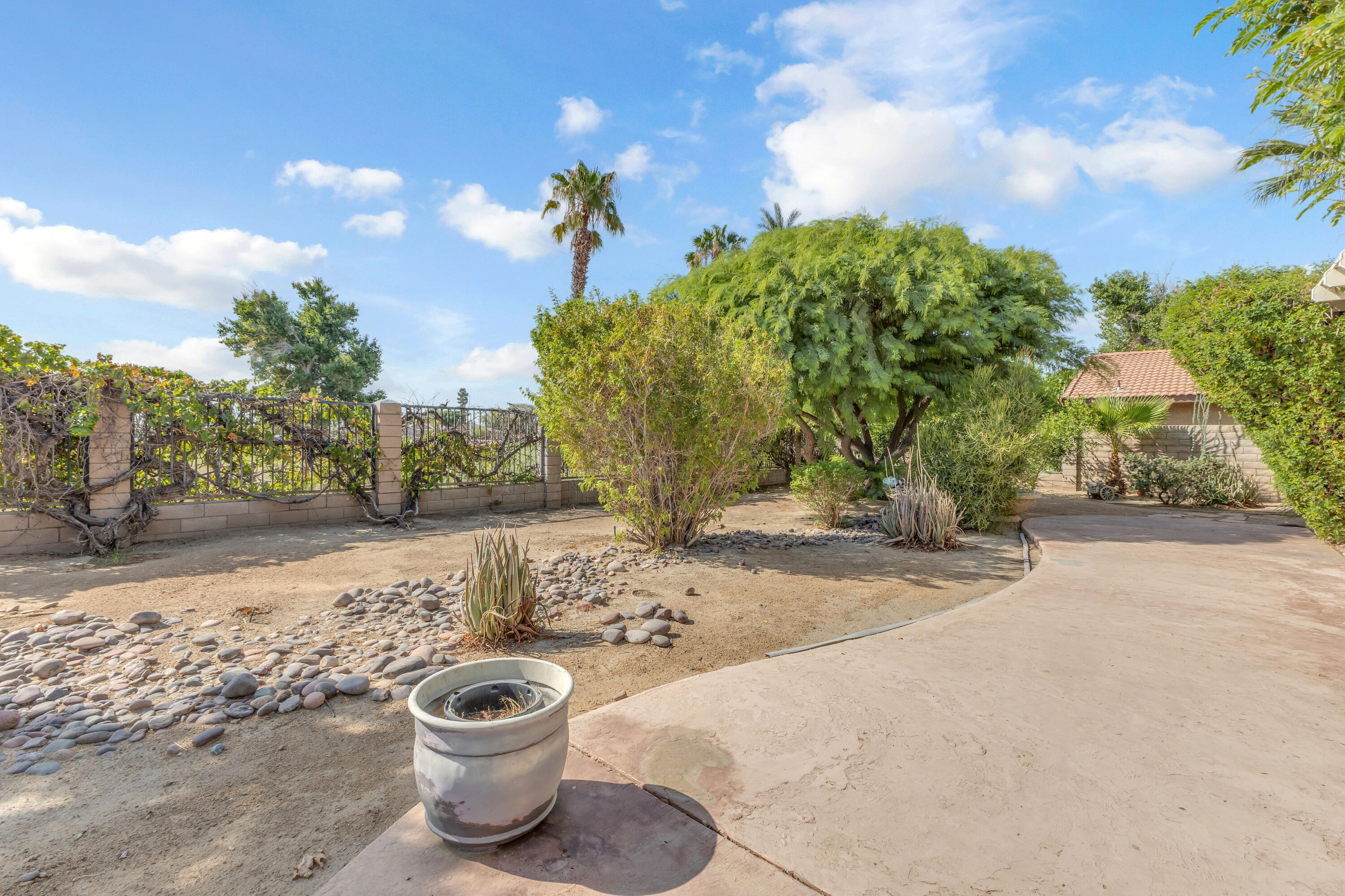 48690 Hepburn Drive Indio, CA 92201 - Photo 23 of 36 a view of a backyard of the house