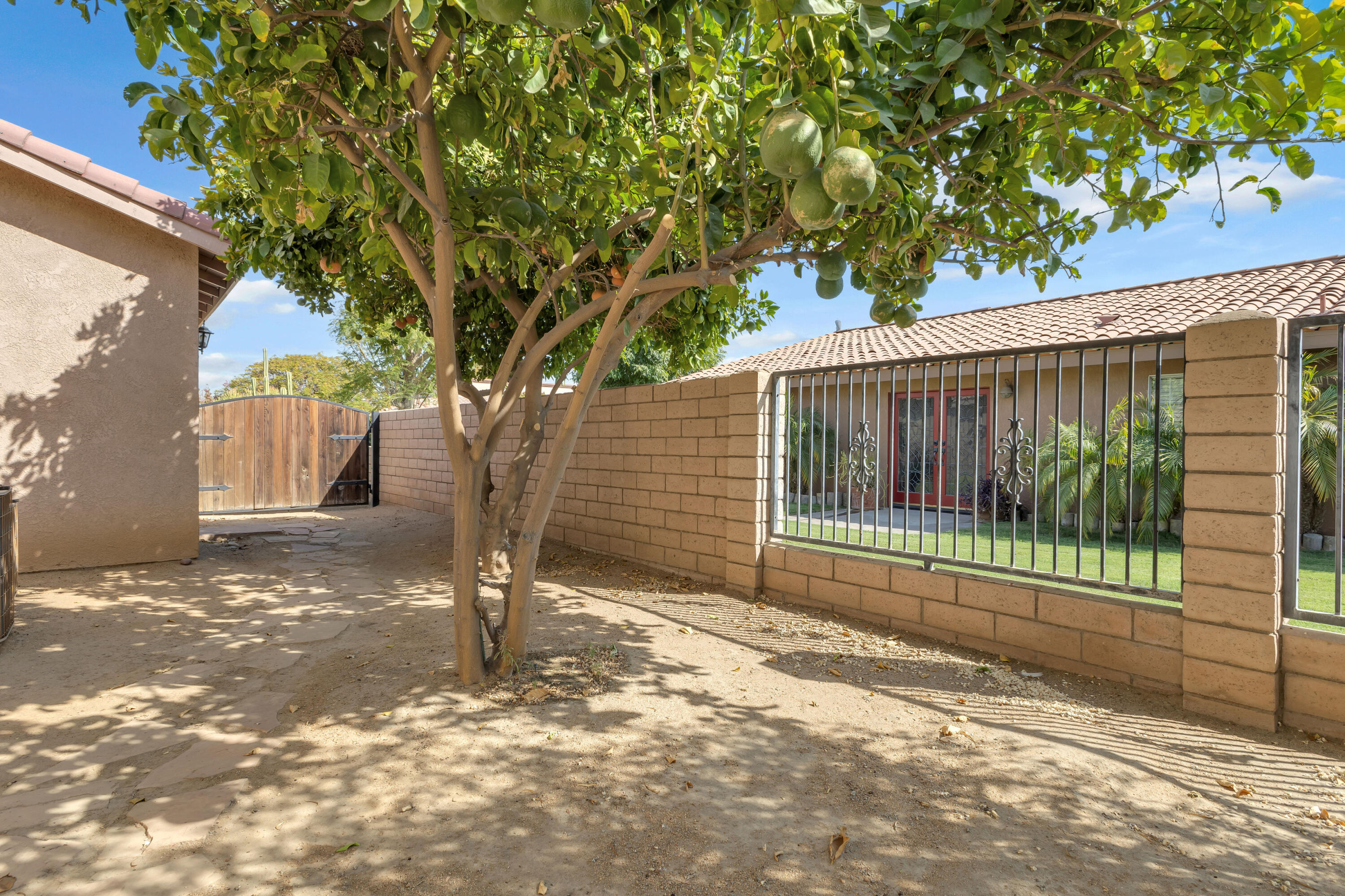 48690 Hepburn Drive Indio, CA 92201 - Photo 24 of 36 a view of a house with a tree in the background