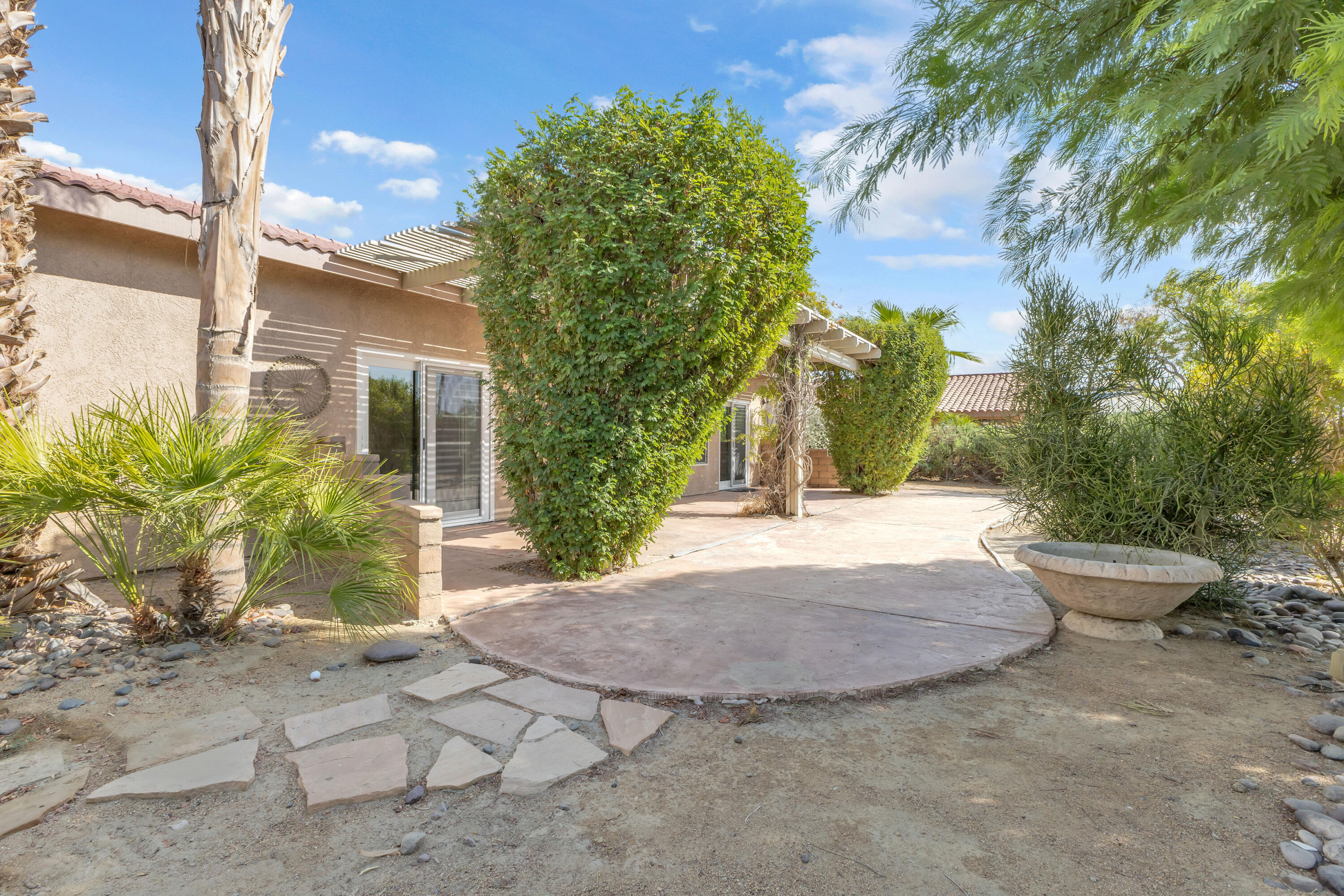 48690 Hepburn Drive Indio, CA 92201 - Photo 29 of 36 a view of a backyard of the house