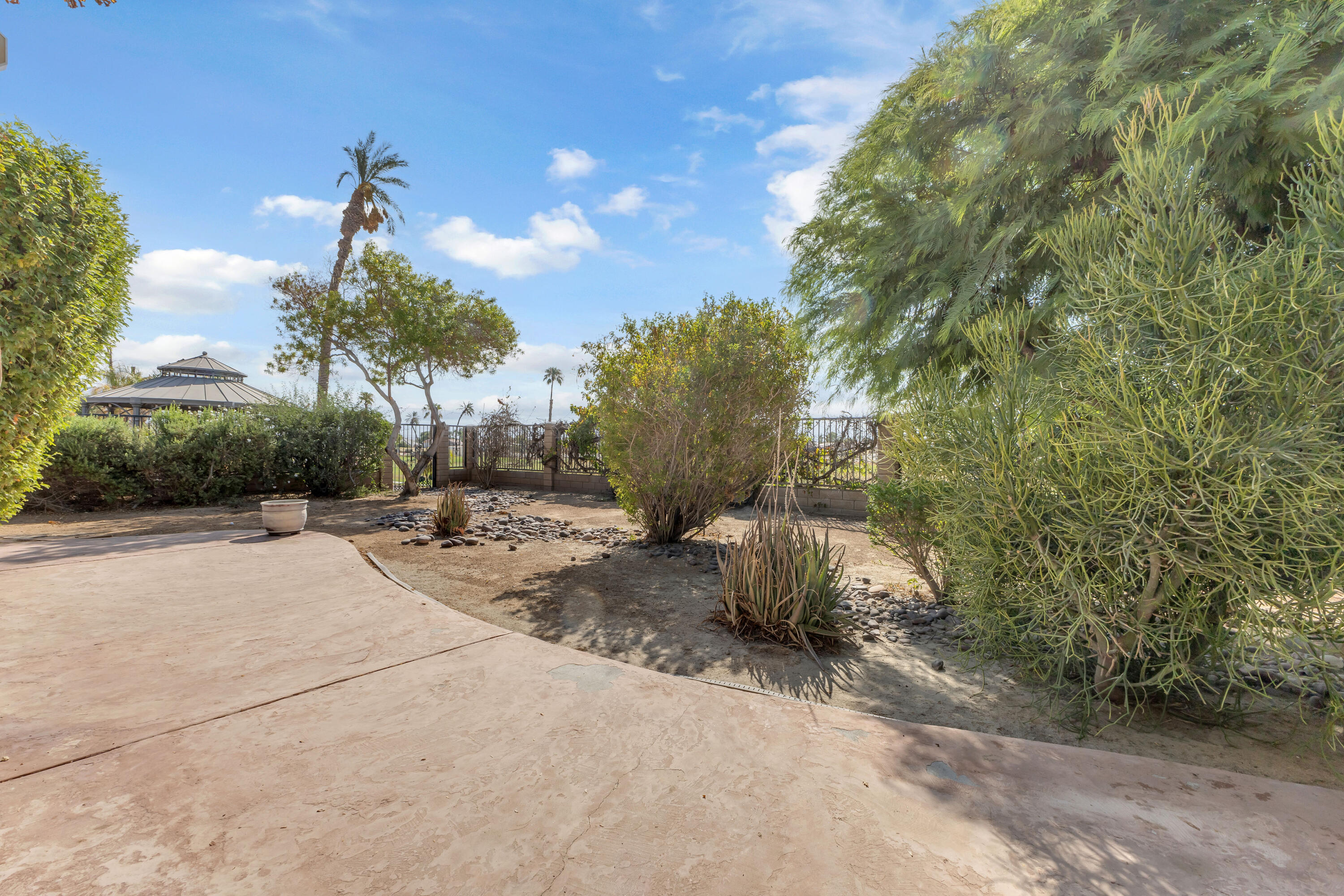 48690 Hepburn Drive Indio, CA 92201 - Photo 30 of 36 a view of a backyard of the house